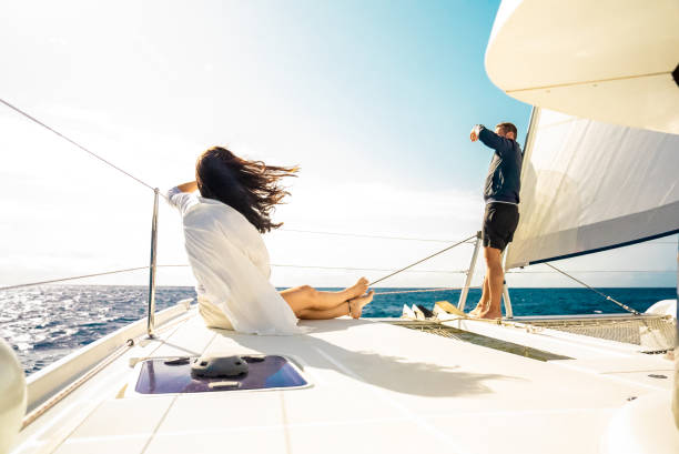 istock Man and Woman on Boat Deck while Spending Vacation Together on Sunny Day 2054998381