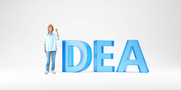 Beautiful young European woman pointing upwards and standing near big idea sign over white background. Concept of planning and brainstorming
