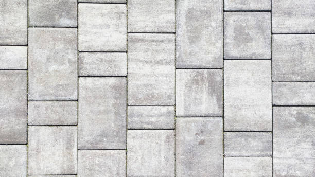 istock High-definition close-up of a grey stone paved road texture. 2055022427