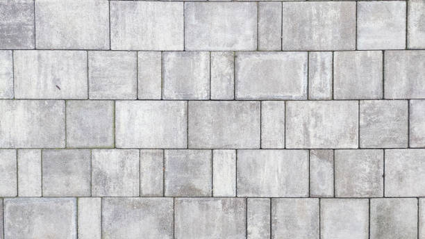 istock Closeup of a gray stone road with paving texture from cement bricks. 2055022487