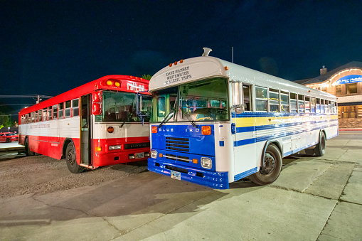 Jackson Hole, WY - July 10, 2019: Public buses at the parking at night.