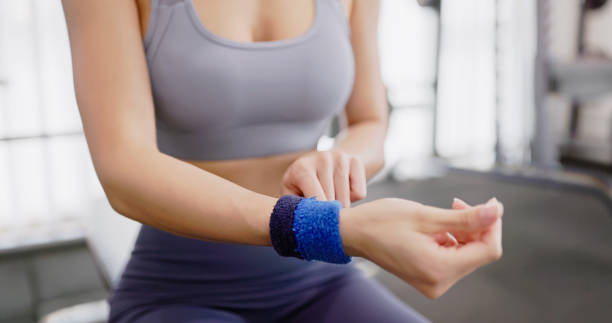 closeup wearing wrise gurads of asian female hand - with confidence ready doing exercise at gym