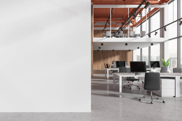 istock Office coworking interior with pc monitors in row, panoramic window. Mockup wall 2055023813