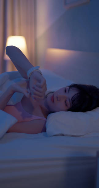 istock asian woman sleep with smartwatch 2055026514