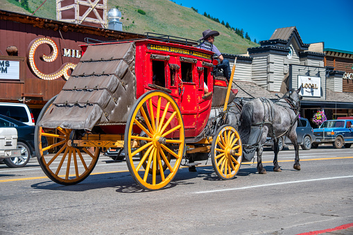 Jackson Hole, WY - July 12, 2019: A colorful horse carriage along the city streets on a sunny summer day.