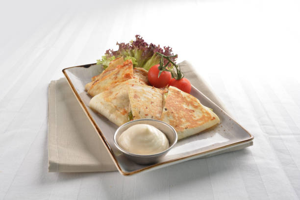 istock chef Mexican pizza wrapped with egg, sausage, bacon, ham and salad dressing in plate on white table restaurant western mixed asian cafe healthy halal menu 2055035554