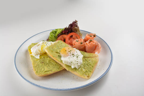 istock western chef luxury breakfast with avocado toast, boiled egg, smoked salmon fish, fried potato cake and salad in plate on white table restaurant western mixed asian hotel cafe healthy halal menu 2055037663