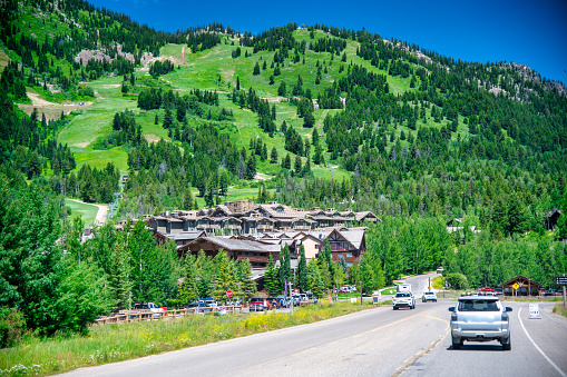 Amazing view of Jackson Village with road and mountains in summer season, Wyoming.