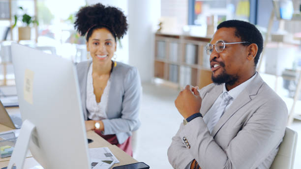 istock Planning, teamwork and business people with a computer for feedback, research and digital marketing. Happy, talking and a black man and woman in corporate with a pc for a collaboration or project 2055057248