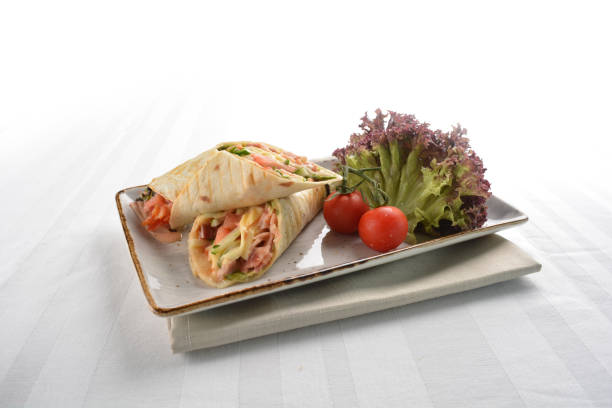 istock chef western tortilla wrapped with ham, cheese and vegetables in plate on white table western restaurant asian halal cafe hotel menu 2055059320