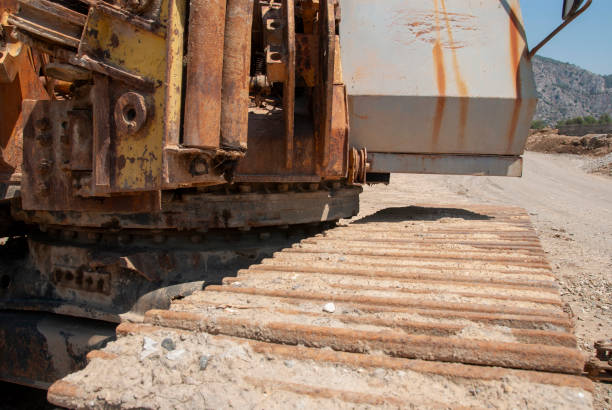 A large yellow bulldozer stands idle atop a concrete overpass, its tracks and blade visible, symbolizing heavy machinery at work in modern infrastructure