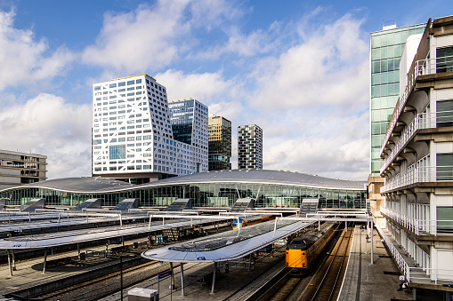 Utrecht, The Netherlands - March 1st, 2024: Utrecht central station with trains, busses and office buildings.
