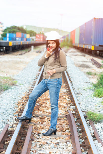Engineer Asia checking railways and call radio for maintenance. Engineer Concept
