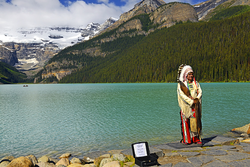 Representative of Nakoda Cree, First Nations Elder on the shores of Lake Louise in Banff National Park, Alberta. Banff National Park is UNESCO World Heritage Site, Canada