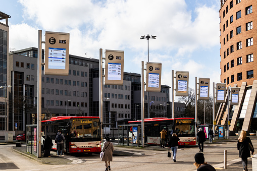 Amersfoort, The Netherlands - March 2nd, 2024: Passengers at bus station downtown Amersfoort, the Netherlands