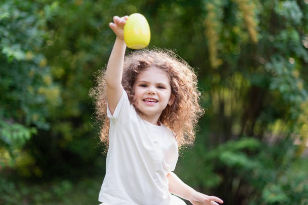 istock Baby with basket full of colorful eggs. Easter egg hunt. 2055121702