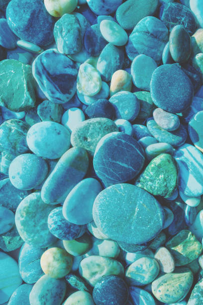 Abstract nature pebbles background. Blue pebbles texture. Stone background. Blue vintage color. Sea pebble beach. Beautiful nature. Turquoise color. Vertical banner