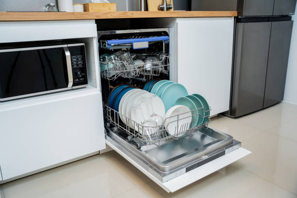 istock The white kitchen and opened dishwasher with clean dishes 2055181699