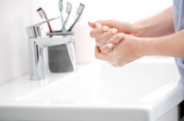 istock Girl Washes Hands With Liquid Soap 2055186948