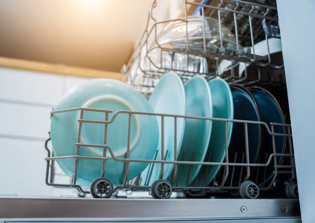 istock The white kitchen and opened dishwasher with clean dishes 2055201183