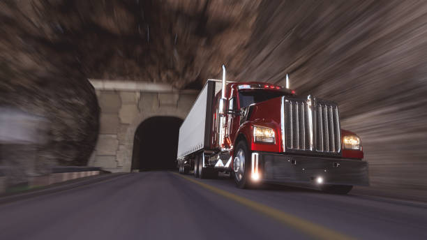 istock American style truck on freeway pulling load. Transportation theme. 3D illustration 2055223235