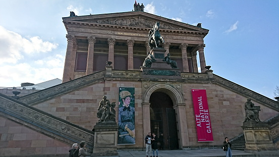 Berlin, Germany - 04.17.2018: Visitors in front of entrance and facade of the Alte Nationalgalerie on a sunny day before the pandemic