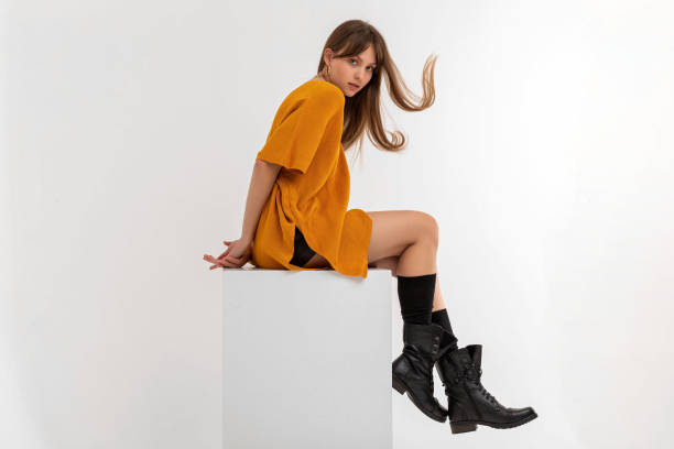 Beautiful business woman. She wears blouse, leather mini skirt and hat.