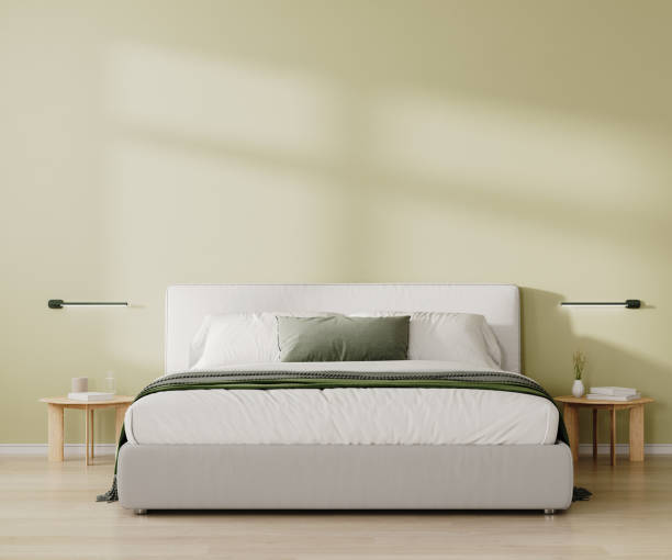istock Modern bedroom interior. King size bed with white and green bedding and pillows, light green wall, 3d render 2055328606