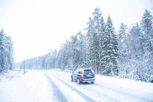 istock Car on the road in winter forest. Snowfall in Finland. 2055352073