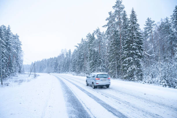 istock Car on the road in winter forest. Snowfall in Finland. 2055352114