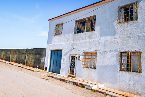 old historic white house somewhere in Empty backroad which are a  style of housing in historic city