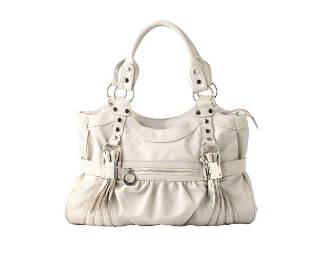 A chic brown leather handbag with a quilted design, highlighted against a serene blue background that gives the composition a calm and luxurious feel. The illumination from below casts a soft glow on the bag, emphasizing its texture and elegant form.