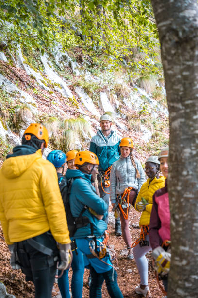 istock Diverse Group of Adventurous People on Zipline Excursion in Forest 2055399749