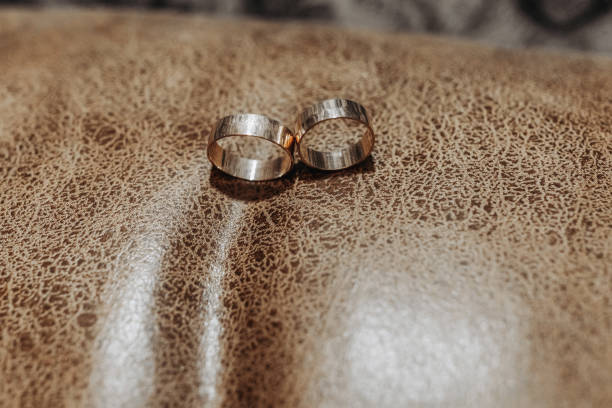 istock gold wedding rings on a textured background 2055401943
