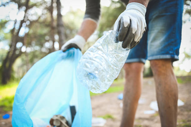 istock male volunteer collecting garbage in the forest 2055422366
