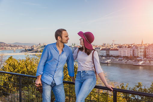 Young couple enjoy his traveling, view point from Gellert Hill in Budapest, Hungary on sunrise.