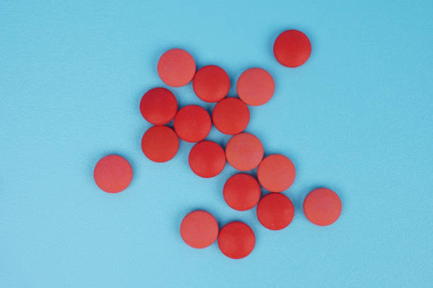 closeup of two red tablets isolated on white background