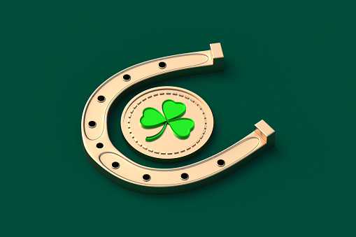 Shamrock on golden coin near horseshoe on green background. St Patrick's Day holiday. Irish tradition. Lucky symbol. 3d render