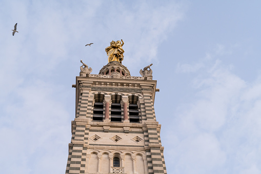 Close-up low angle view of Notre-Dame de la Garde in Marseille city of France. Exploring beautiful French architecture.