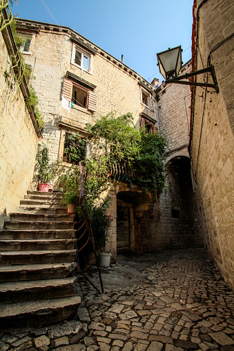 Trogir, Croatia - August 21, 2020 - Scenic narrow, typical mediterranean alley in downtown Trogir, Croatia