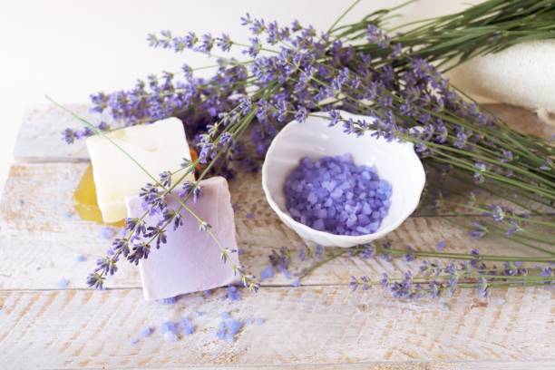 Lavender bath salt, natural soap and fresh lavender flowers on wooden background