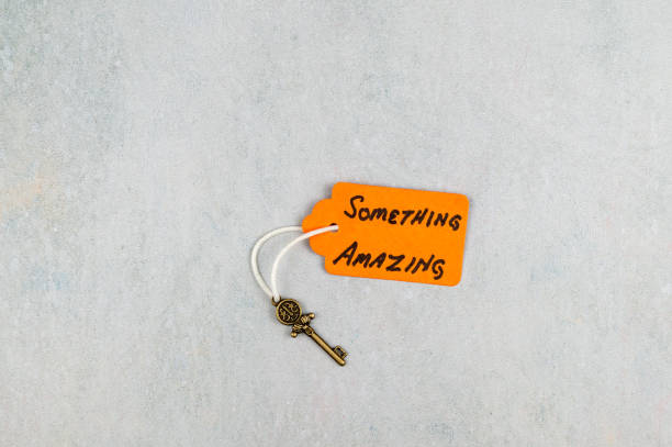 house shape keyring and house keys against yellow background