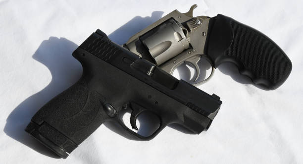 istock Two different handguns placed one on top of the other 2055552058
