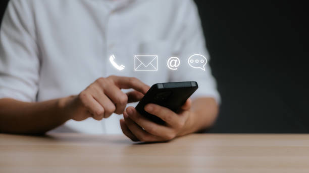 istock Customer support hotline Contact us people connection. Businessman using Smart Phone with the 2055573546