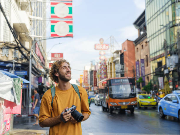 istock Man photographing with camera in Chinatown, Bangkok 2055581531