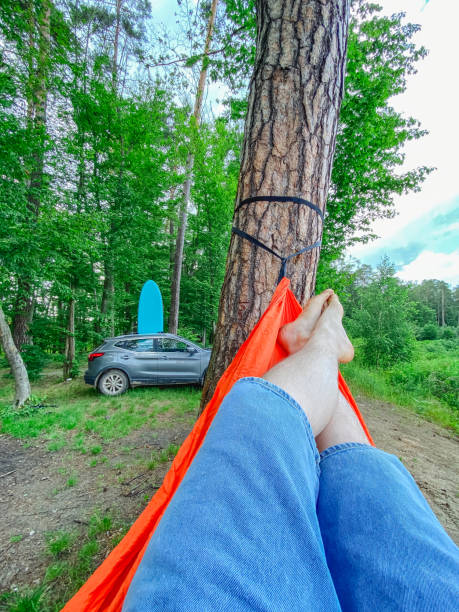 pov man laying down on hammock car with supboard on background copy space
