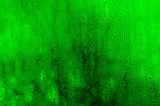istock The background is wet glass. green texture 2055614213
