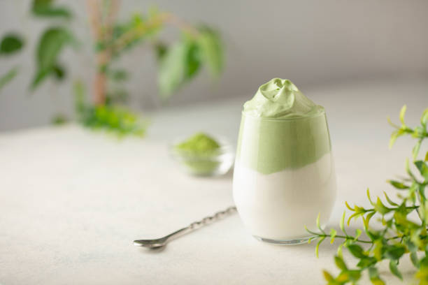 istock Dalgona Matcha Latte, a creamy whipped matcha in glasses, on light background. 2055628105
