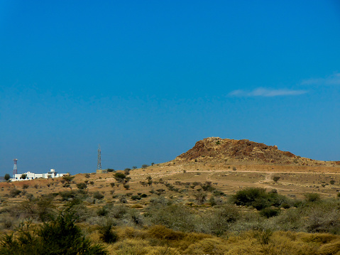 A panoramic view of the savannah grassland habitat and the rock mountain in the Middle East.