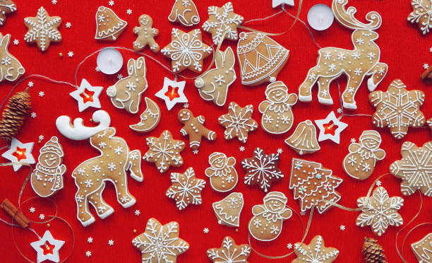 istock Holiday Cheer with Festive Gingerbread Decorations. A Vibrant Red Background Adorned with Traditional Christmas Cookies and lights 2055636526